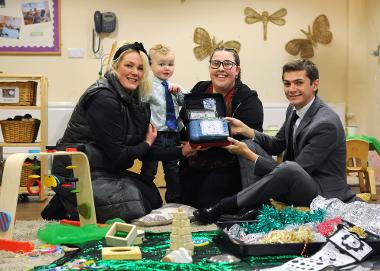 Mam Alexandra Maria Dellorusso is pictured with son Emerald, key worker Laura Phipps and Cllr Ellison with the defibrillator