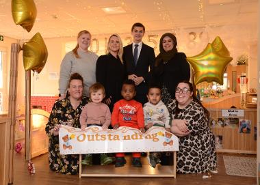 Cllr Adam Ellison (centre) is pictured with staff and children at Stanleys at Marine Park celebrating the Outstanding Ofsted result. 