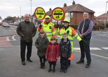 Councillor Ernest Gibson is pictured with school crossing patrols Wendy Pounder and Edith Mason, Mortimer Primary School Head Teacher Peter Bennett, and children Emily (age 6), Bethany (age 3) and Dylan (age 6).