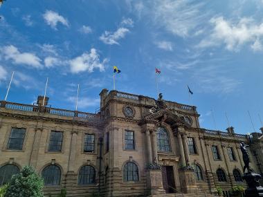 The County Durham flag flies alongside the Union flag and Borough flag.