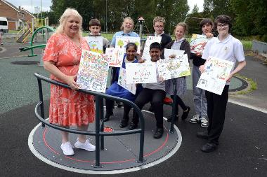 Councillor Audrey Huntley is pictured with some of the children and the winning designs that are being displayed in play parks across South Tyneside.