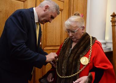 New Mayor Councillor Fay Cunningham receives the Chains of Office from outgoing Mayor, Councillor John McCabe.