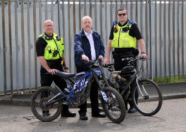 PC Darren Lough, Cllr Jim Foreman, PCSO Callum Thompson with seized bikes